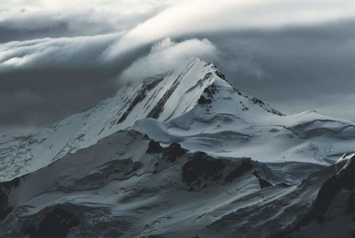 snow covered mountain under white clouds