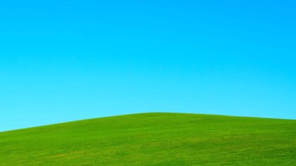 green hill under blue sky