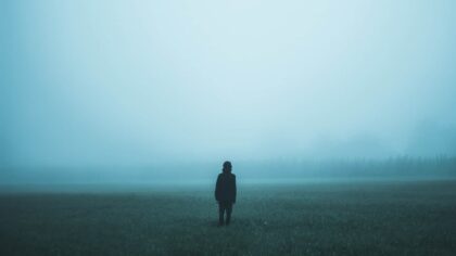 person standing on misty ground