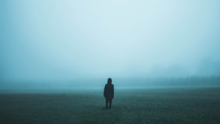 person standing on misty ground