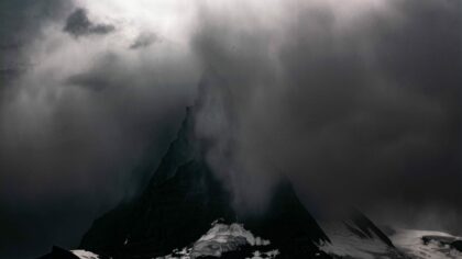 mountain during snow season covered with fog